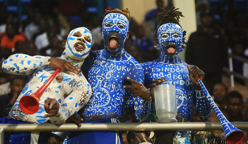 Three Rayon Sports fans painted in the club's colours. Seen here before the match  look so hopeful to win the game.