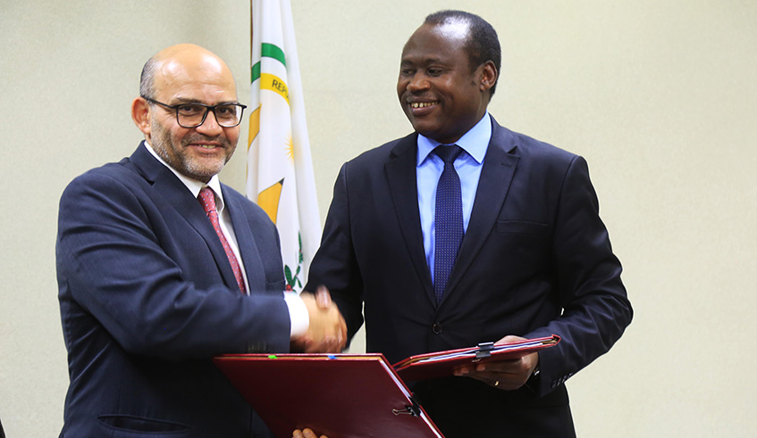 World Bank Country Manager Yasser El-Gammal (left) and Minister for Finance and Economic Planning Uzziel Ndagijimana exchange documents after signing  the MoU in Kigali yesterday. Sam Ngendahimana.