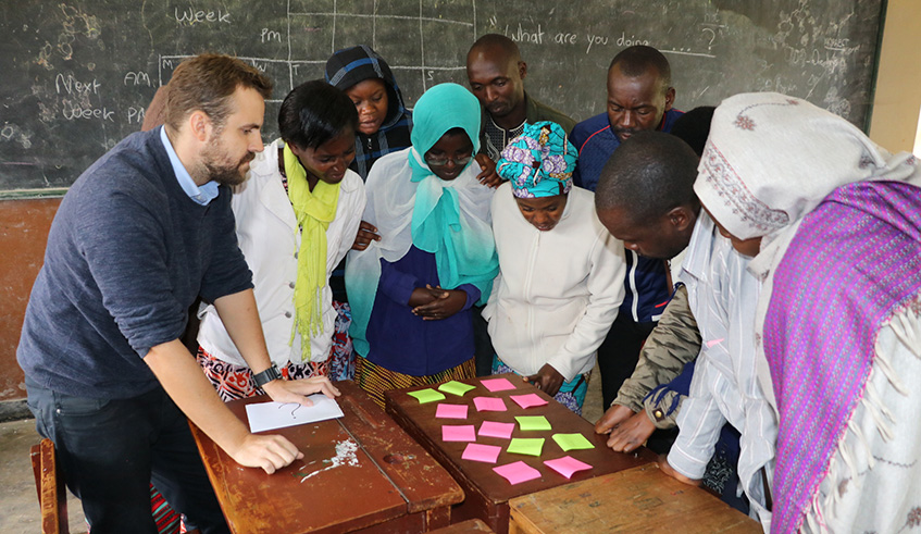 English teachers use learning materials during the training at TTC Byumba in Gicumbi District. Ru00e9gis Umurengezi.