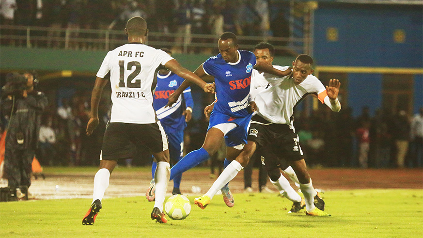 Rayon Sports midfielder Olivier Sefu Niyonzima (center) vies for the ball with APR skipper Jean Baptiste Mugiraneza during the 2-1 loss at Amahoro Stadium on Wednesday. Sam Ngendahimana.