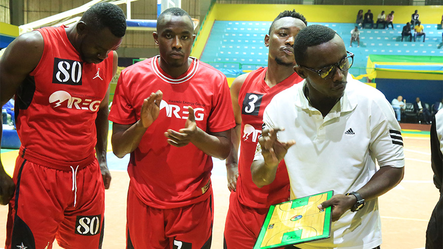 REG head coach Patrick Ngwijuruvugo briefs (right) his players during a time-out in a past preseason tournament game against Espoir at Amahoro Indoor Stadium. Sam Ngendahimana.