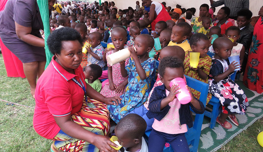 Officials give milk to children