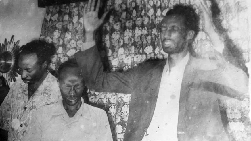 Kazimili (right) prays alongside some of his colleagues in undated photo. Courtesy.