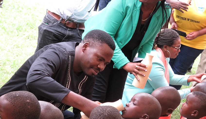 Officials give milk to children