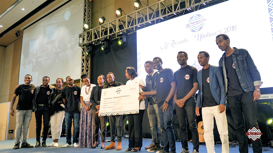 One of the winning groups (photography, cinematography and animation) pose with a dummy Rwf10 million cheque.