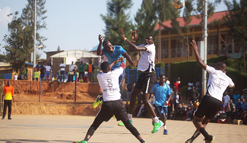 APR Handball club players vie for the ball against a Police handball club defender during the final match of the league at Kimisagara. Sam Ngendahimana.