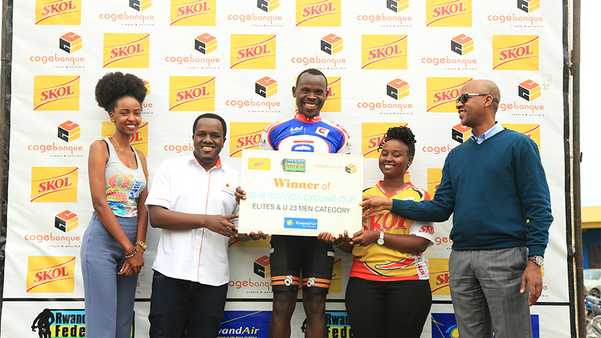 Gasore Hategeka (centre) receives his certificate of recognition from Rwanda Cycling Federationu2019s president, Aimable Bayingana (right), after winning the 2018 Rwanda Cycling Cup at Amahoro Stadium on Saturday. Sam Ngendahimana.