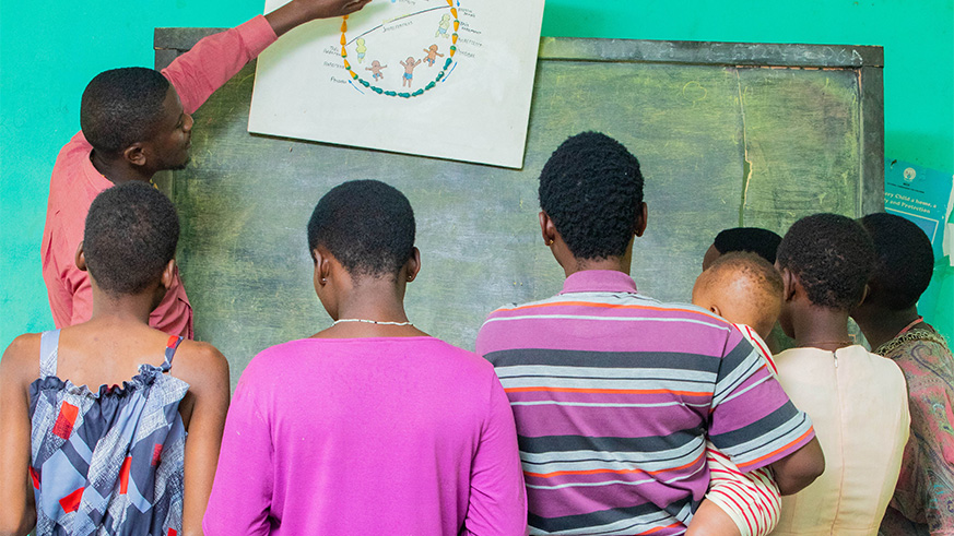 Teenage mothers at Centre Marembo in Gasabo District being taken through the reproductive cycle by a health worker at the centre last week on Thursday. All the young mothers are victims of sexual violence and are sheltered at the centre that receives teenage girls, mainly from the streets, who have been victims of domestic or sexual violence. While at the centre, the young girls receive education, counseling and trailing in life skills and stay there until they get employment or are reunited with their families.  Emmanuel Kwizera.