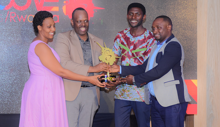 Dr Fidele Masengo of Foursquare Gospel Church and his wife  (left) give an award to Goshen Choir members. photo by Frederic Byumvuhore