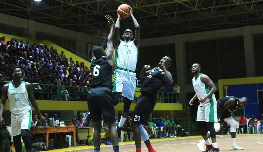 Espoir skipper Emile Galois Kazeneza, 19, flies high for a spectacular dunk during a preseason tournamentu2019s game against APR at Amahoro Stadium last month, which ended 75-69 in favor of Espoir. Sam Ngendahimana.