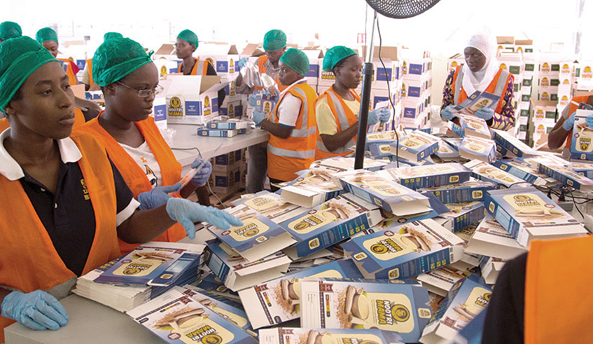 Workers at Africa Improved Foods factory in Kigali assemble packages for fortified foods. File.