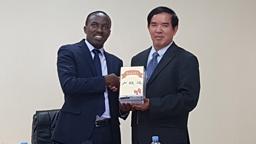 Rwanda Agricultural Board Director General Patrick Karangwa shakes hands with Dr Liu Guodao after signing a pact that will see Chinese experts help to reduce post harvest losses in Rwanda. Michel Nkurunziza.