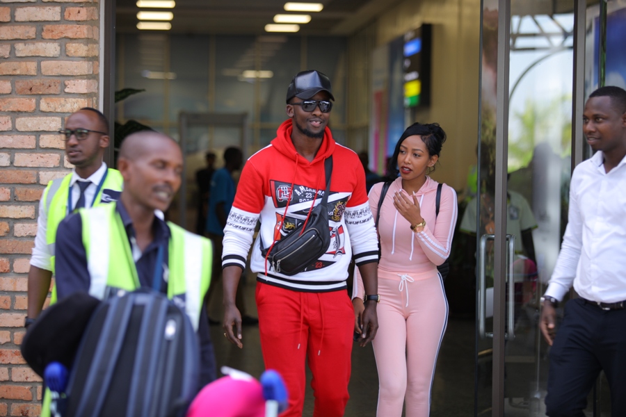 Meddy (wearing a red tracksuit) arrived in the country with his girlfriend. / Courtesy