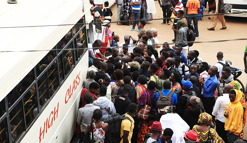 Passengers travelling upcountry for Christmas scramble to board a bus at Nyabugogo main park yesterday.  Sam Ngendahimana.