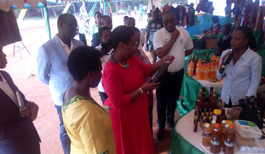 RDB chief executive Clare Akamanzi (in a red dress) inspects locally made products in Kicukiro District last week.Photo by Michel Nkurunziza.