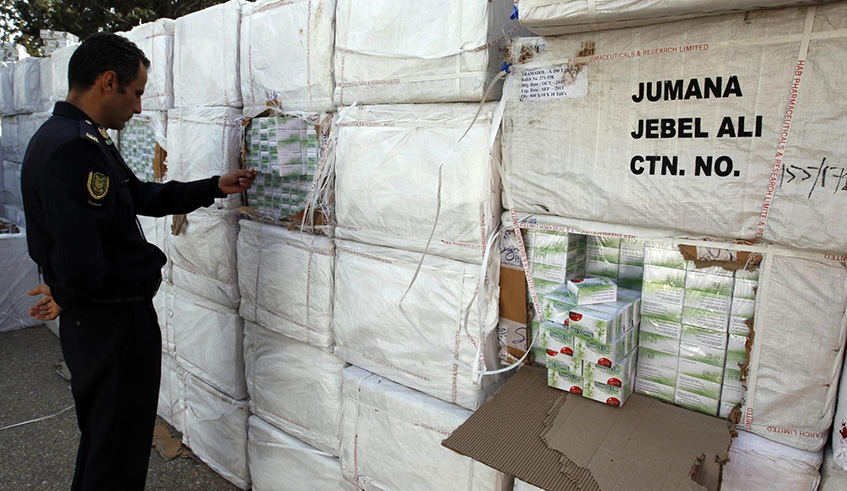 A Libyan police officer views a haul of prescription drug Tramadol seized from a shipping container in Tripoli. Net photo.