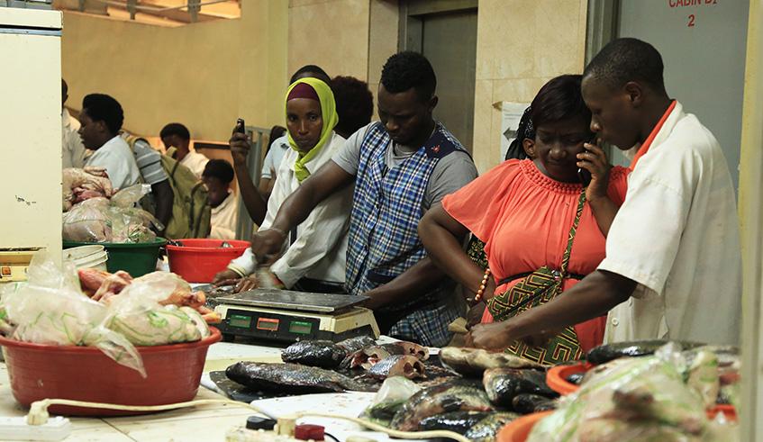 Fish traders in Nyarugenge City Market in downtown Kigali. Many traders, especially those selling foodstuffs said they cashed in on the Christmas last-minute shoppers. Rwandan Christians will today join the rest of the world to celebrate Christmas Day in honour of the birth of Jesus Christ. Sam Ngendahimana.