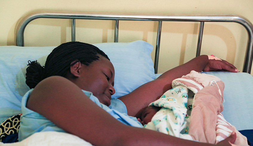 Aline Niyitegeka, a mother from Kicukiro District, with her new born after a safe delivery at La Croix du Sud in Kigali yesterday. Emmanuel Kwizera.