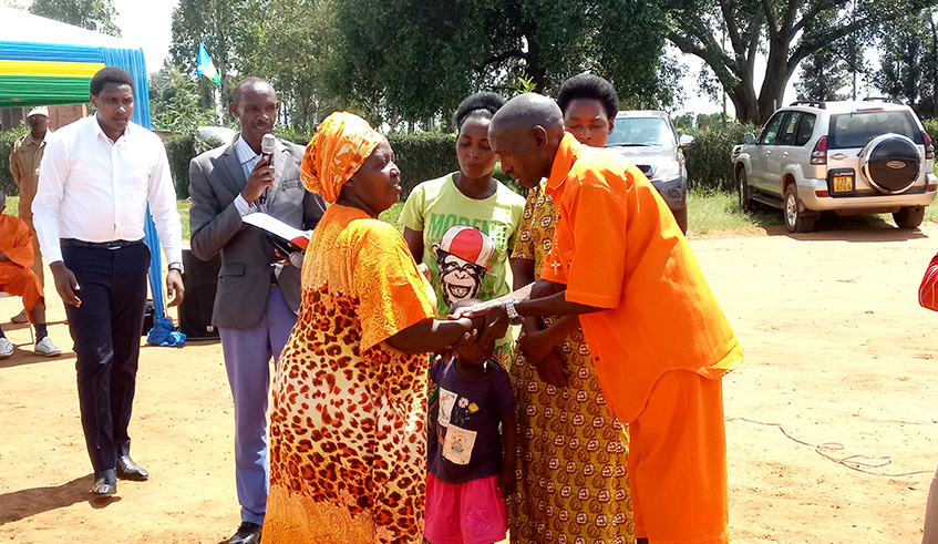 A genocide survivor shakes hands with a convict after the latter apologised for having killed her relatives. This was during the event in Ntarama Sector, Bugesera District on Thursday. Jean dâ€™Amour Mbonyinshuti.