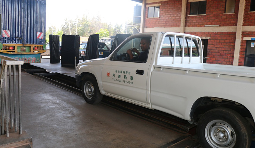 Rwanda National Police technician inspects a vehicle through a computer. Courtesy. 