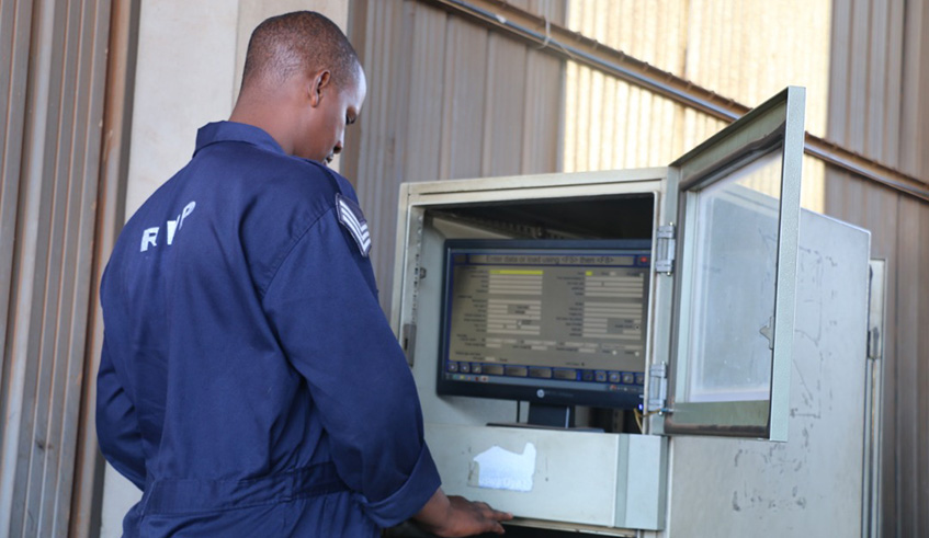 Rwanda National Police technician inspects a vehicle through a computer. Courtesy. 
