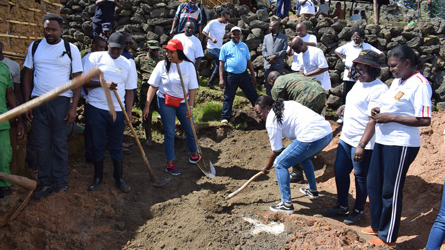 The members of the Rwandan Communities Abroad (RCAs) participate in refurbish houses for vulnerable people from Shingiro Sector in Musanze District during umuganda. Regis Umurengezi