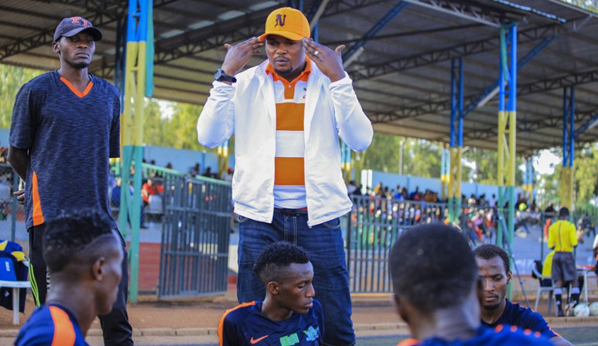 Lomami Marcel briefs his players. Courtesy.