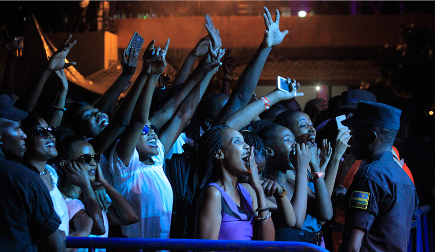 Revellers cheer on an artist during a performance in Kigali. Police has called on the public to celebrate responsibly. Sam Ngendahimana.