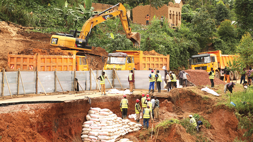 Workers from Horizon Group fix the damaged section of the Kigali-Gatuna highway in Cyumba Sector in Gicumbi District following a landslide in the area last year. File.