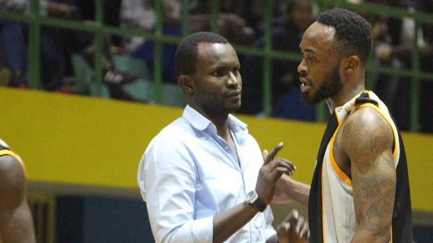 APR basketball club head coach Aime Karim Nkusi gives instructions to shooting guard Bryan Mbanze during a past league match against REG at Amahoro Stadium. File.