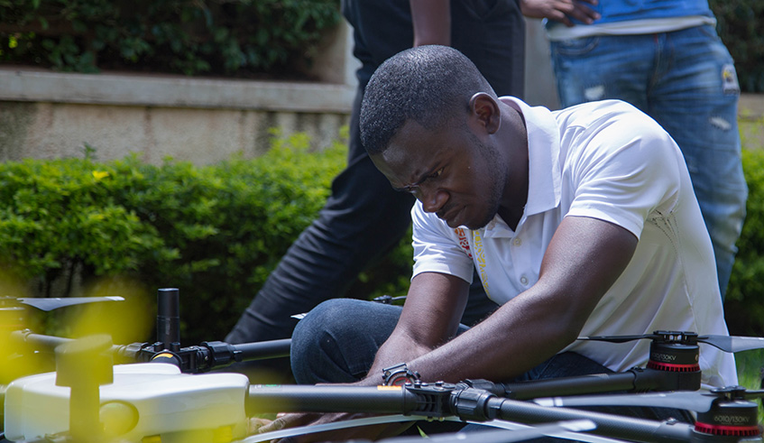Teddy Segore, one of the pilots with Charis test-flies one of the drones to be deployed in the spraying of larvicide that will target mosquito-prone areas across the country to curtail malaria spread. Nadege Imbabazi.