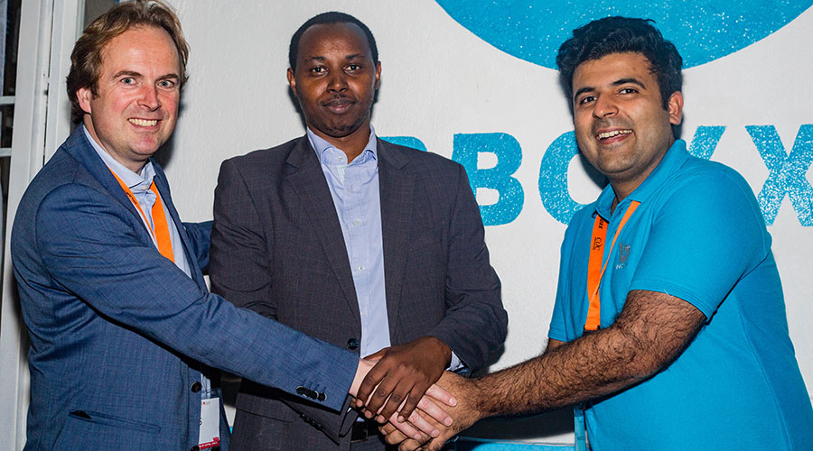 Robert Nyamvumba, Energy Division Manager at Ministry of Infrastructure, who was also the chief guest at the launch of Rural Home 2025, shakes hands with BBOXX Global CEO Mansoor Hamayun (R) and the Executive Director of GOGLA Association, Koen Peters.