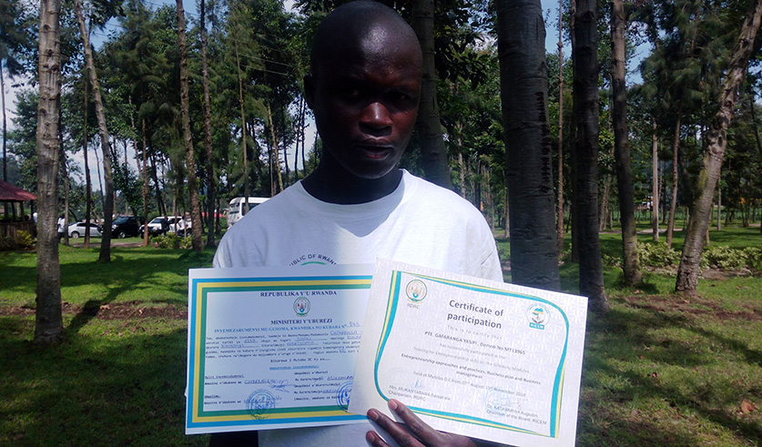 Gafaranga poses with two certificates that he was awarded with in November 2018 after completing a three-month civic and entrepreneurship course at Mutobo Demobilisation Centre in Musanze District. Photos by Ru00e9gis Umurengezi.