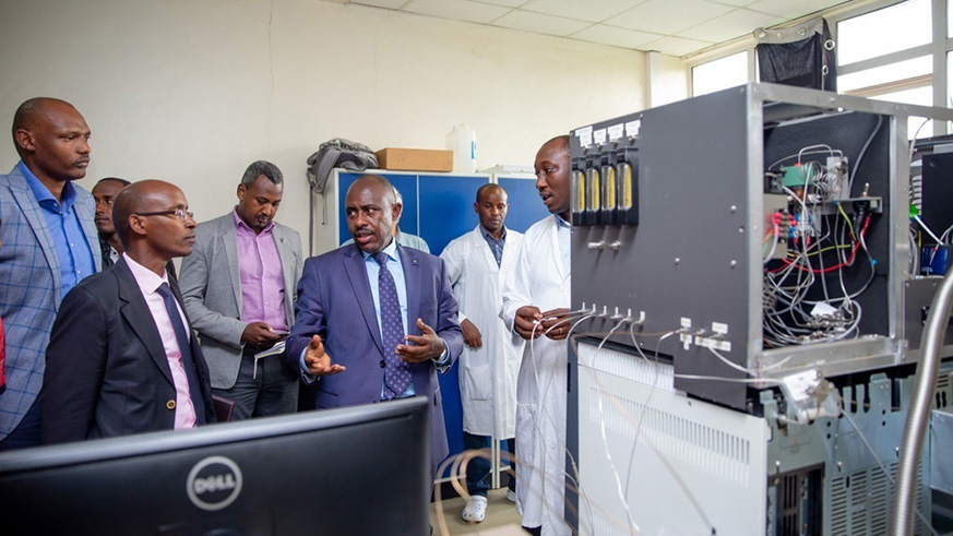 Minister for Education Eugene Mutimura (centre) talks to officials during the launch of the first African Air Quality and Climate Laboratory at University of Rwandau2019s College of Science and Technology on Friday. The facility is equipped with the u201cMedusa systemu201d that will measure more than 50 gases that deplete the ozone layer.  Mou00efse  Niyonzima.