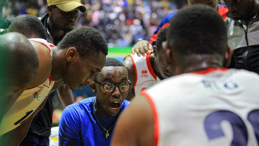 REG Basketball  Club head coach Patrick Ngwijuruvugo gives instructions to his players during a past league match against Patriots at Amahoro Indoor Stadium. Courtesy.