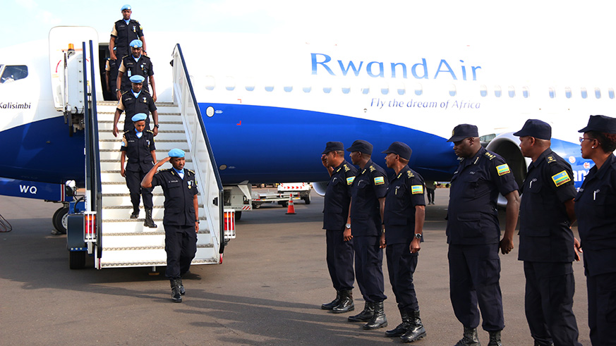 A contingent of 140 Rwanda National Police officers yesterday jetted off to the Central African Republic aboard a RwandAir flight for a one-year peacekeeping mission under the United Nations Multidimensional Integrated Stabilisation Mission in the Central African Republic (MINUSCA). It replaces another contingent of the same strength  that touched down at Kigali International Airport (left), yesterday, under the command of ACP Emmanuel Hatari (saluting). Courtesy.  