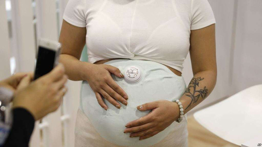 A model wears the Owlet Band pregnancy monitor at the CES International in Las Vegas. The device can track fetal heart rate, kicks and contractions. Net.
