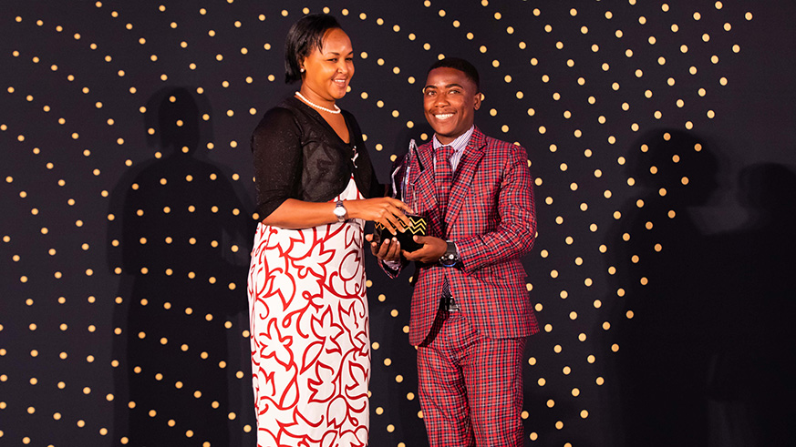 Jean Marie Vianney Habiyaremye, (R) the 2018  RDB Business Excellence Awards Young Entrepreneur of the Year receives his award from Minister for Youth Rosemary Mbabazi. Emmanuel Kwizera.