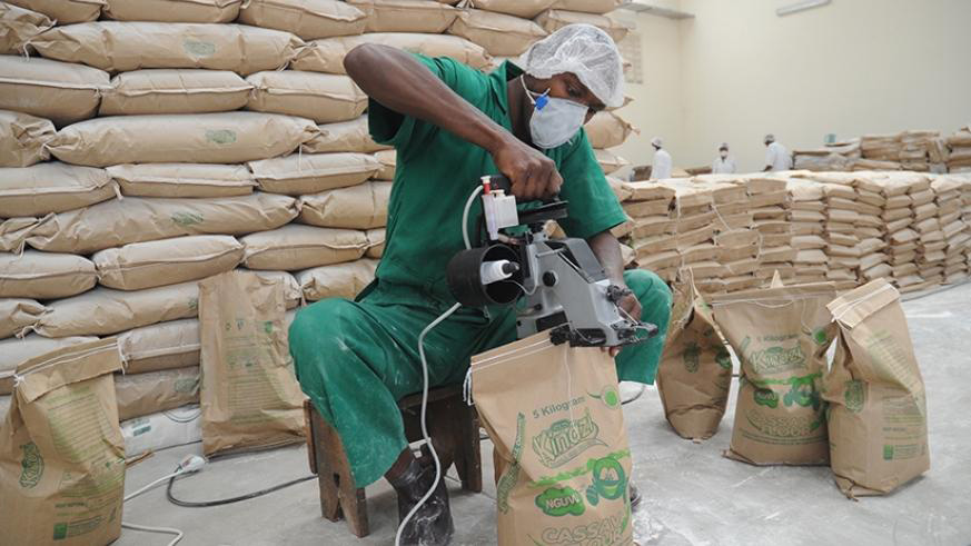 A staffer packs cassava flour at Kinazi Cassava Plant in Ruhango District. File.