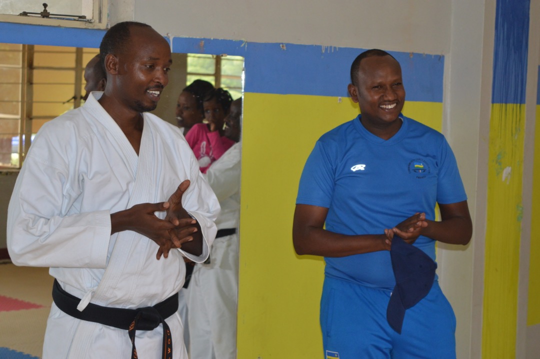 John Ntigengwa (right), Permanent Secretary in the Ministry for Sports and Culture (Minispoc), and Dr. Sabin Nsanzimana, president of Lions Karate-Do School, talk to club members after a training session on Sunday. Courtesy