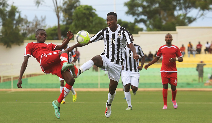 APR FC forward Lague Byiringiro (#14) vies for the ball with Kirehe FC midfielder Prosper Nzabonimana during a past league match at Kigali stadium. Sam Ngendahimana.