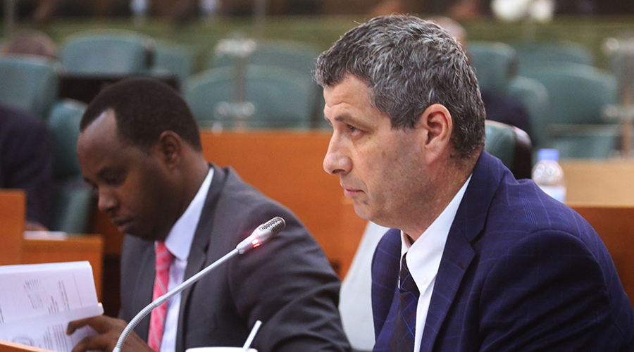 Rwanda Energy Group Chief Executive Officer Ron Weiss addresses senators during the meeting yesterday. He is being flanked by Robert Nyamvumba, the Acting Board Chairman of the utility body. / Sam Ngendahimana