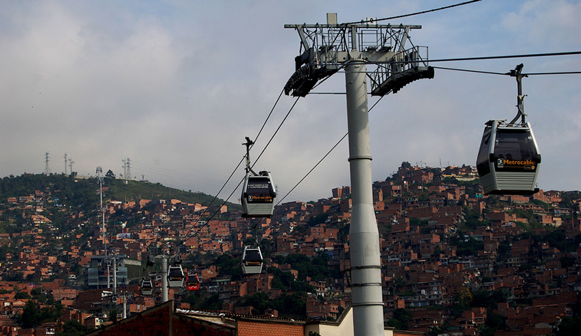 Cable car line passing above Medellinu2019s city parts in Colombia. Previously, mobility of people was limited due to high steep sloppy mountains.  Net photo.
