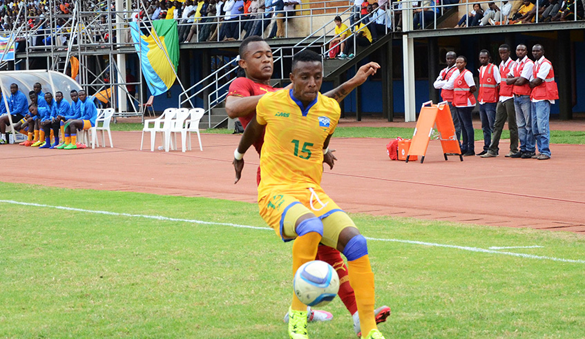 Former APR defender Emmery Bayisenge shields the ball from Ghana forward Jordan Ayew during a past AFCON qualifier at Amahoro Stadium. Sam Ngendahimana.