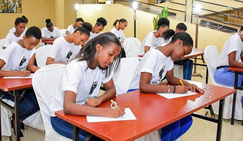 The contestants doing the writing challenge. Organisers say the challenges aim at preparing them for international pageants such as Miss World. /Courtesy photo