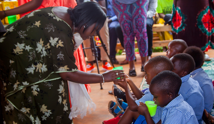Amb. Soline Nyirahabimana, Minister of Gender and Family Promotion feeds children with Milk at Gisagara School Based ECD Center