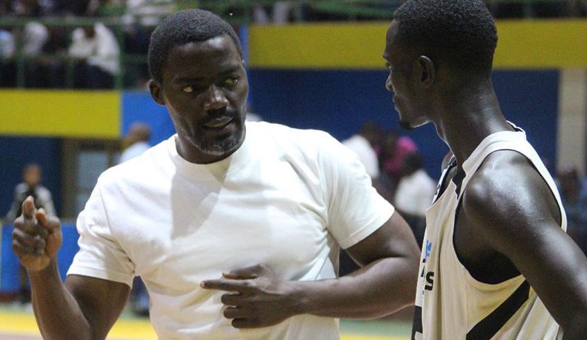 Patriots point-guard Sedar Sagamba (R) takes instructions from head coach Henry Mwinuke during a past league game at Amahoro Stadium. File.