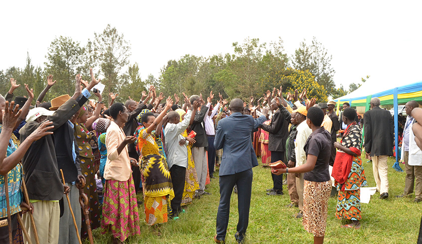 Survivors (on the left side) and perpetrators (on the other side), put hands up to show that they reconciled. Courtesy Photos.