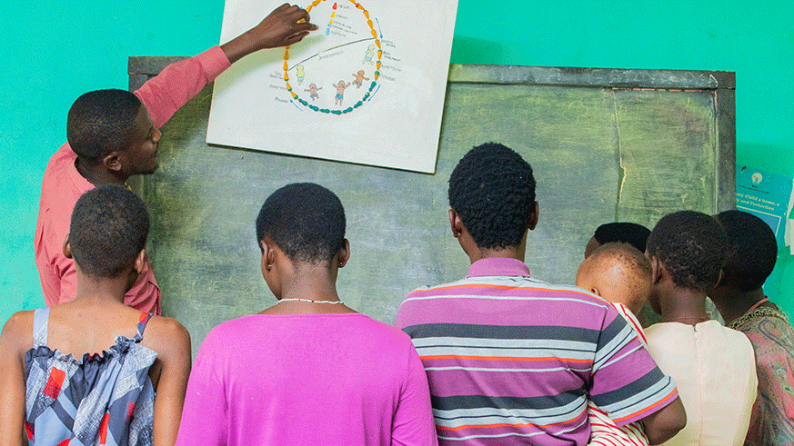 Teenage mothers at Centre Marembo in Gasabo District being taken through the reproductive cycle by a health worker at the centre last month. Emmanuel Kwizera.
