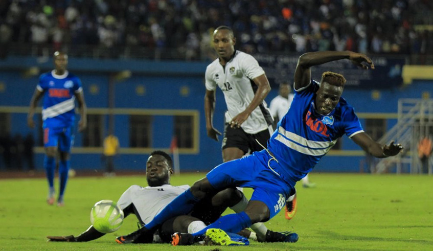 APR centre-back Herve Rugwiro tackles Rayon Sportsu2019 Ghana-born striker Micheal Sarpong (in blue) during a past league match at Amahoro Stadium, which ended 2-1 in favour of APR. File.